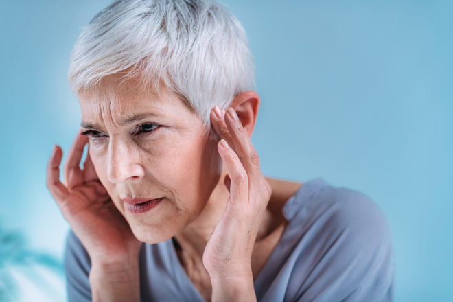 A New York woman is massaging near her ears to find pain relief from her tinnitus.