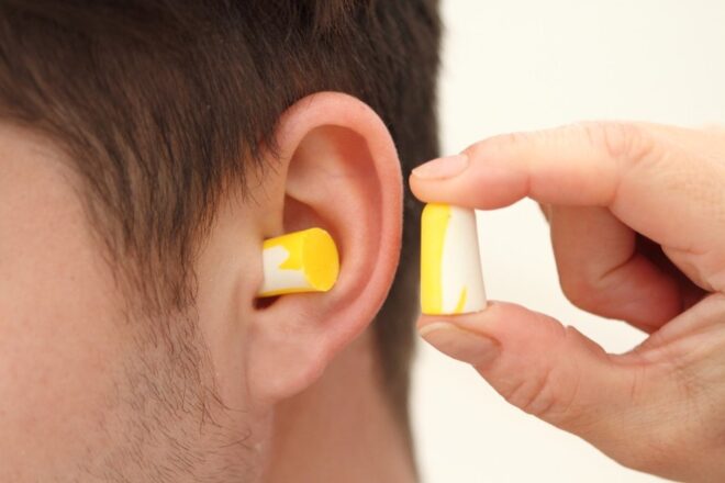 Yellow ear plugs for preventative hearing loss care.